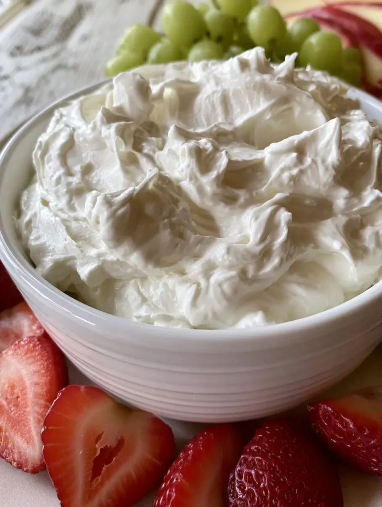 Frischkäse-Frucht-Dip: Der fluffigste 3-Minuten-Nachtisch für jede Party 1 Frischkäse-Frucht-Dip in einer Keramikschale, umgeben von frischen Erdbeerhälften und grünem Obst.